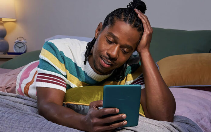 Gifts for book lovers: eReaders open up almost limitless reading A man lying on a bed reading on a Kindle Paperwhite.