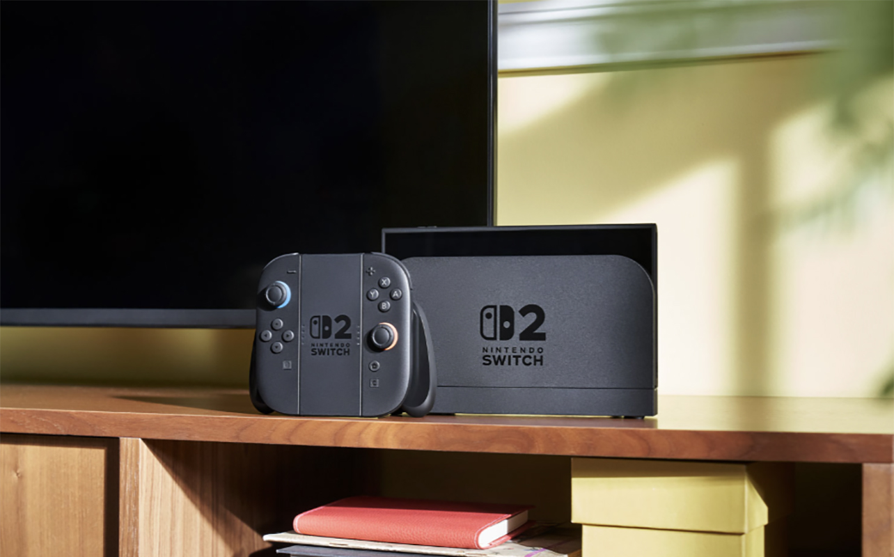 The Nintendo Switch 2 on a table by a TV.