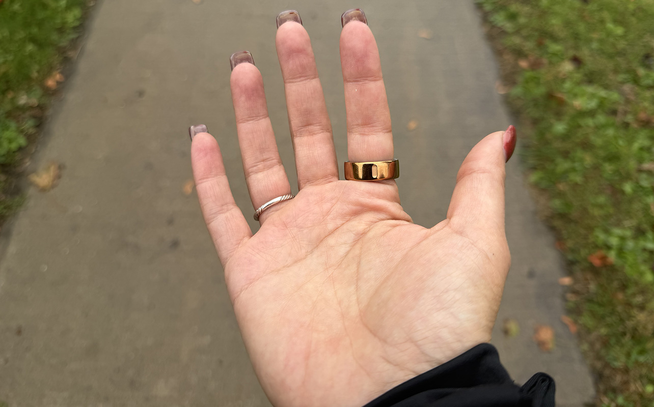The underside of a hand wearing the Oura Ring 4, showing the notch on the bottom.