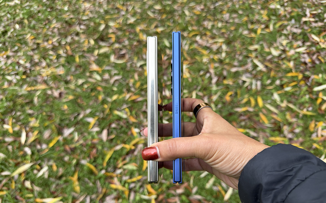 A hand holding the Google Pixel 10 Pro Fold and Samsung Galaxy Z Fold 7 sideways