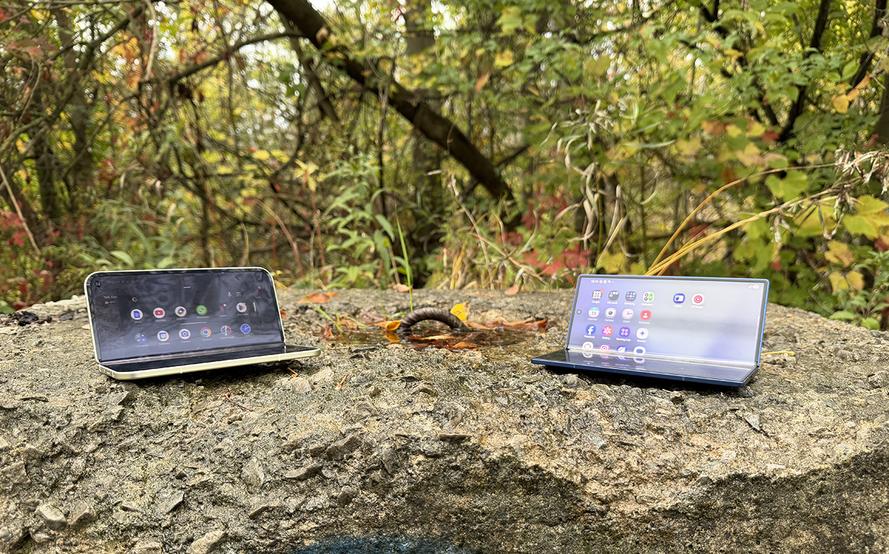 Google Pixel 10 Pro Fold and Samsung Galaxy Z Fold 7 tented on a tree stump.