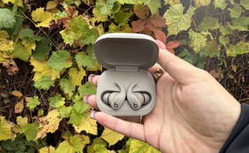 Built to move: the Powerbeats Fit are the perfect workout companion Powerfits Fit earbuds in case open in front of Fall leaves.