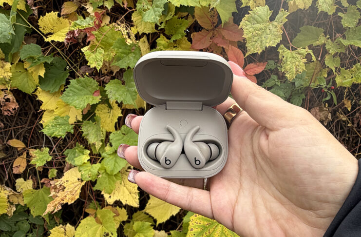 Built to move: the Powerbeats Fit are the perfect workout companion Powerfits Fit earbuds in case open in front of Fall leaves.