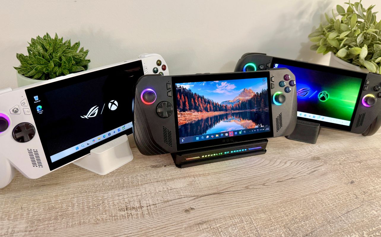 The ASUS family of devices with Windows 11 desktops on their screens with two green plants on either side of the desk.