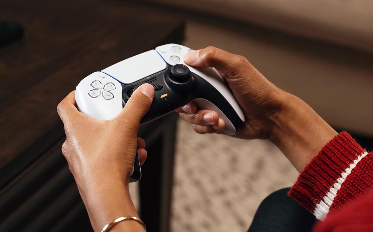 Joueur utilisant une manette sans fil supplémentaire DualSense pour PlayStation 5.