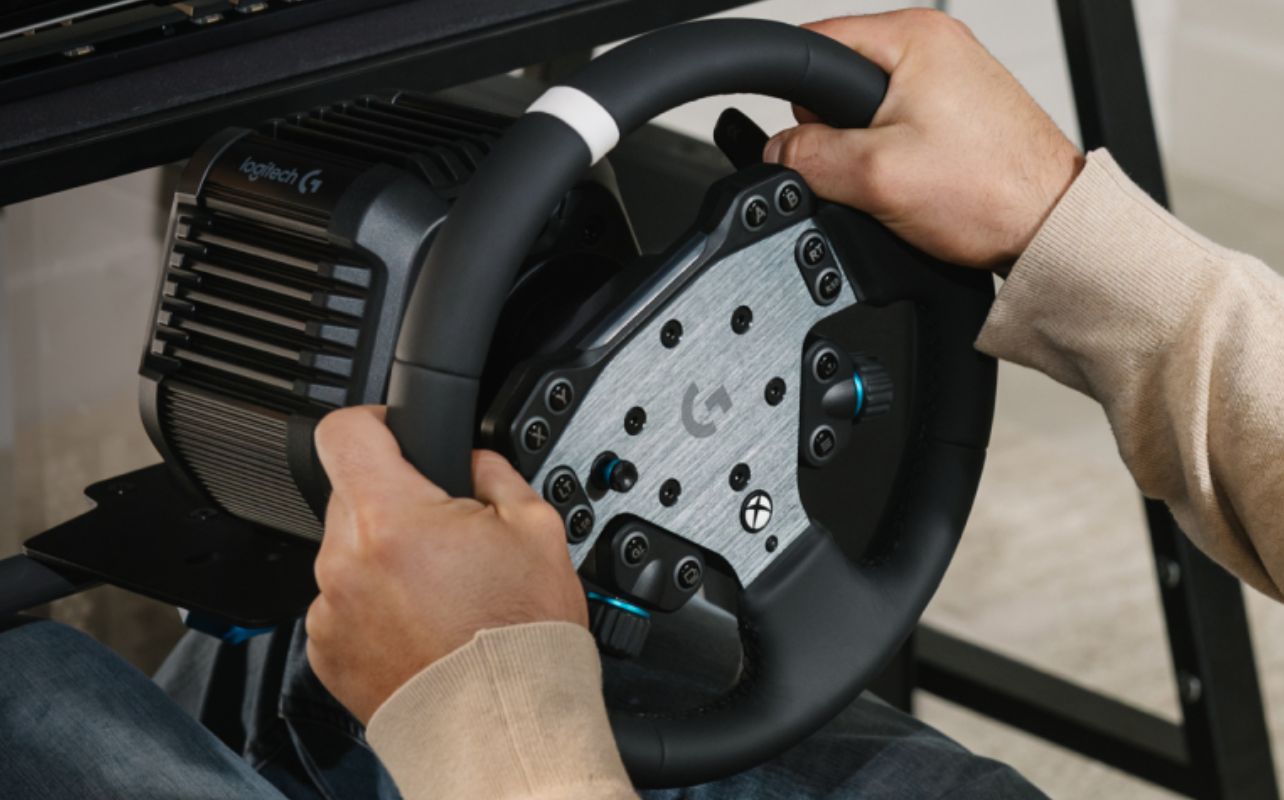 The Logitech G RS50 Racing Wheel in action with a racer using it.