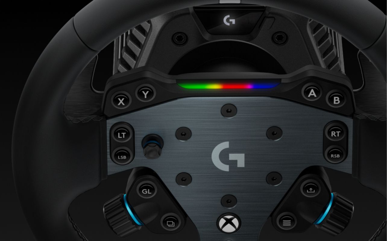 The Logitech G RS50 Racing Wheel, shown in close-up with a lit rainbow-coloured band of light.