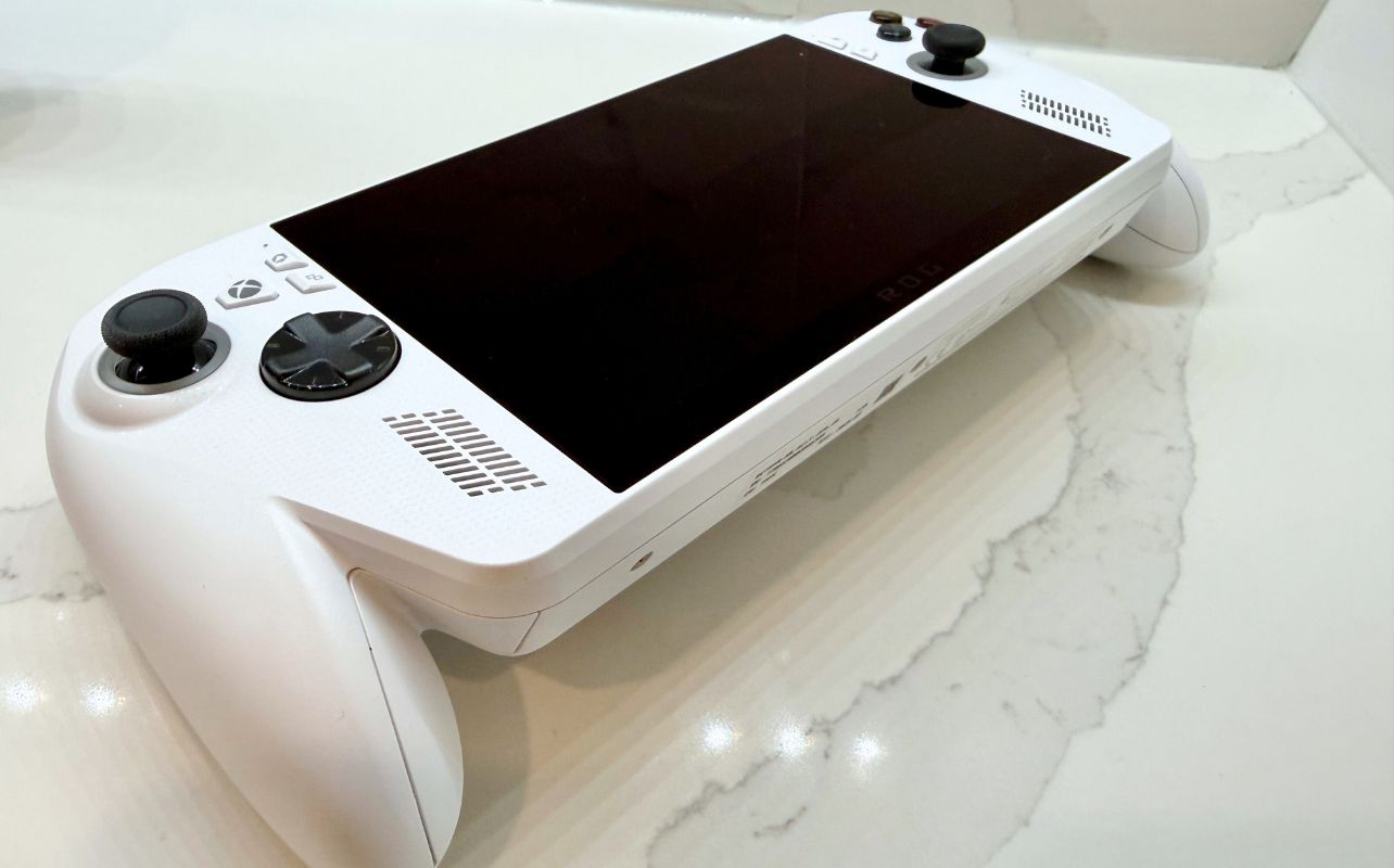 A white ROG Ally lies flat on a countertop.