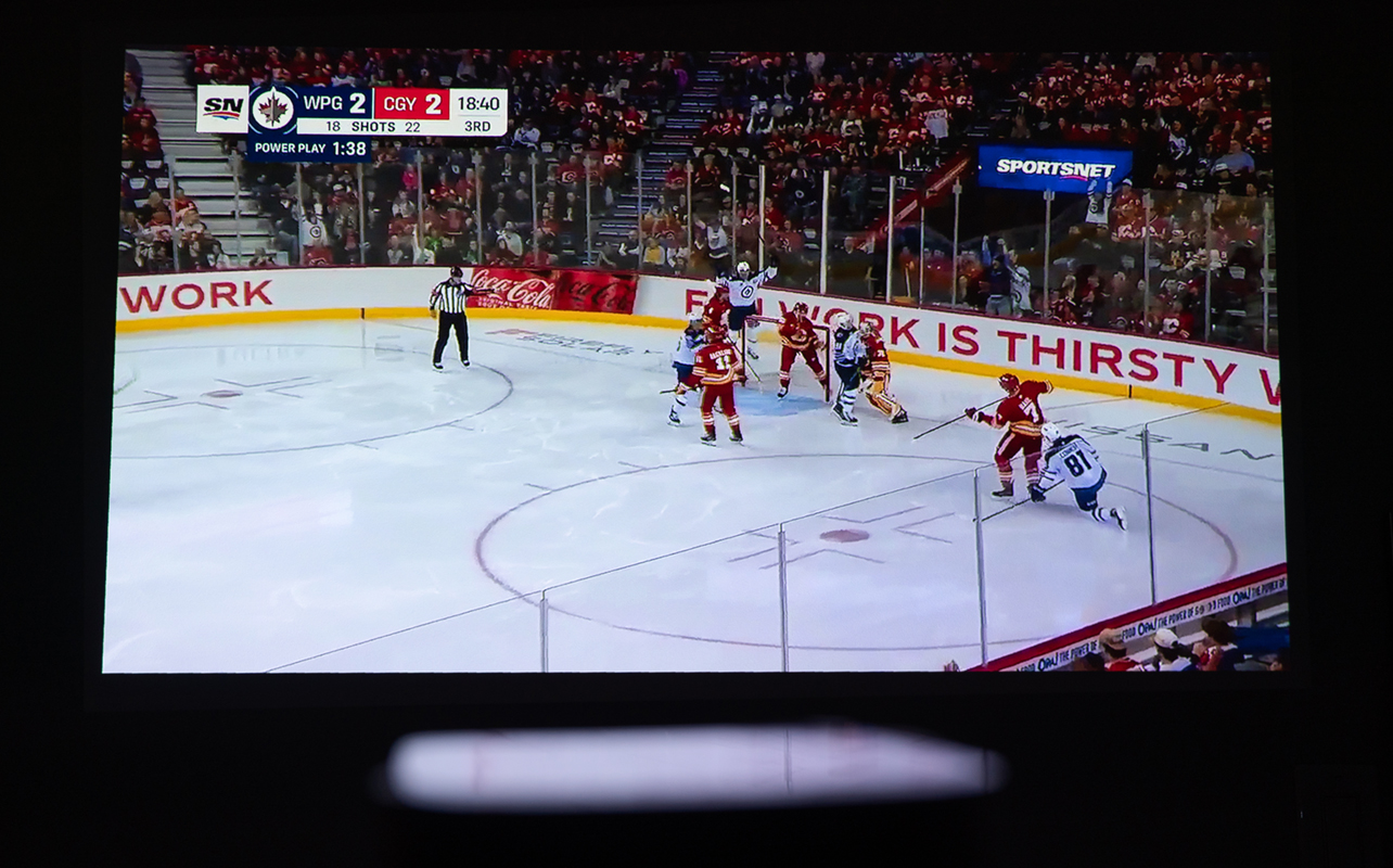 Watching hockey projected on wall using XGIMI Halo+.