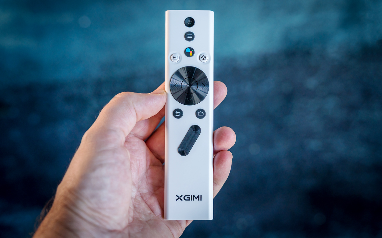 XGIMI Halo+ remote in hand.