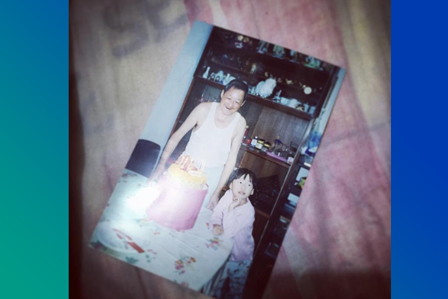 Smiling Grandpa, a little girl, and a huge fruit cake.
