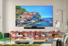 An LG C5 OLED TV mounted on a wall in a living room.