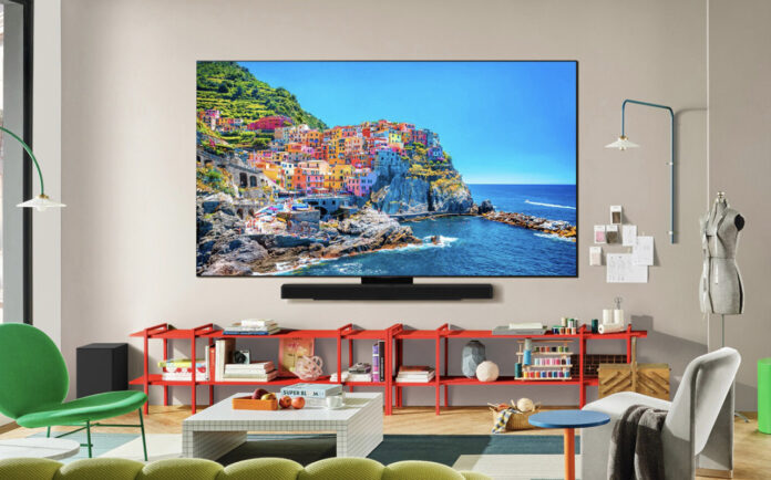 Different OLED TV technologies, explained An LG C5 OLED TV mounted on a wall in a living room.