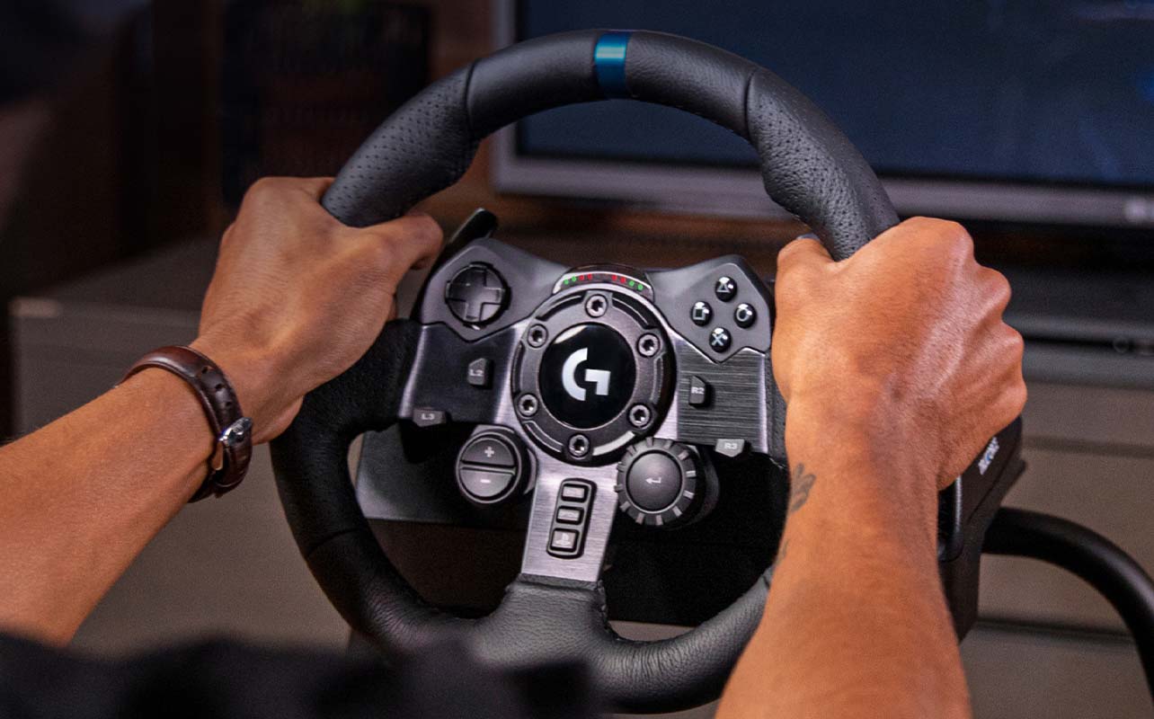 A person gripping a Logitech racing wheel.