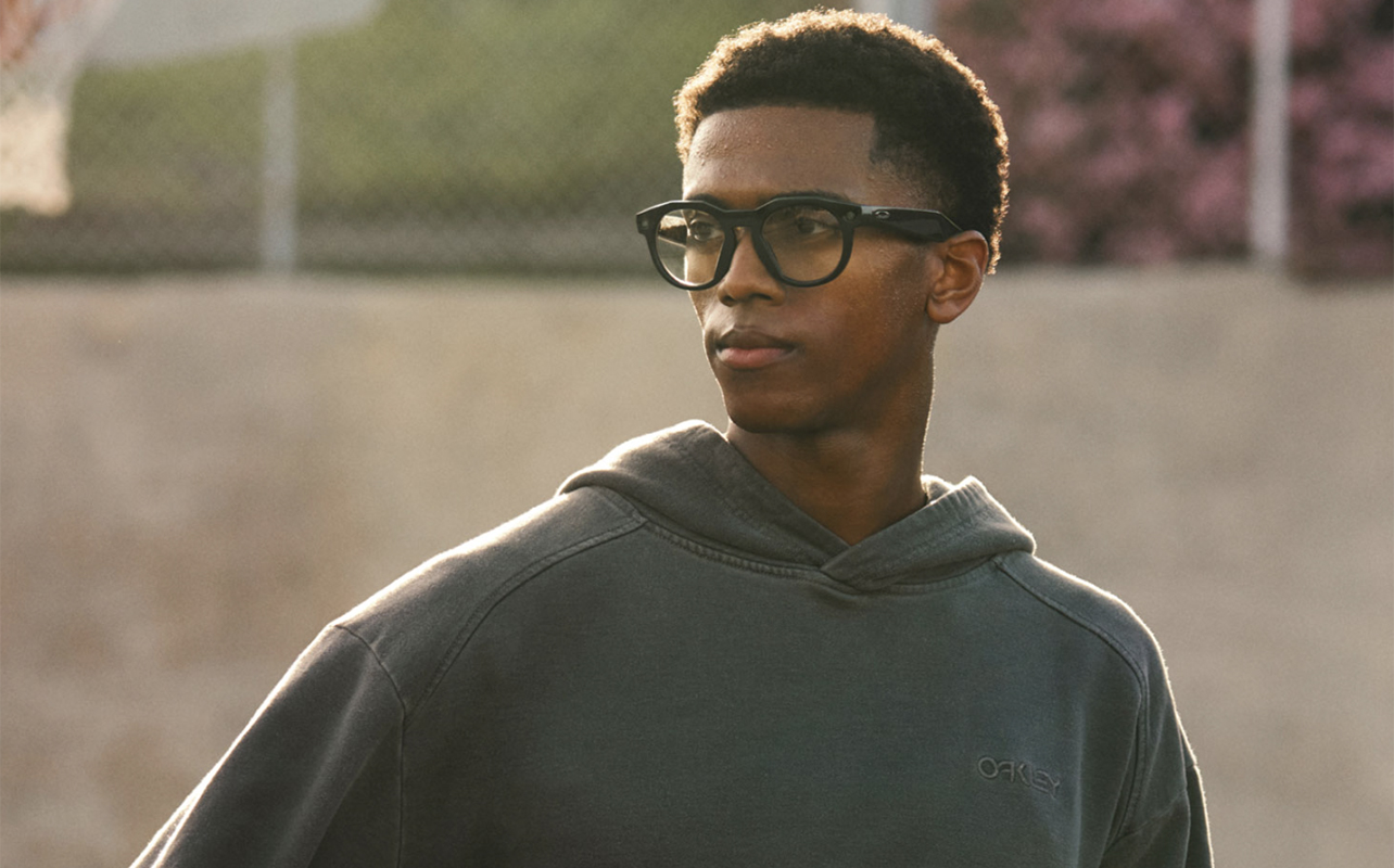 A young man wearing the Meta Oakley AI glasses