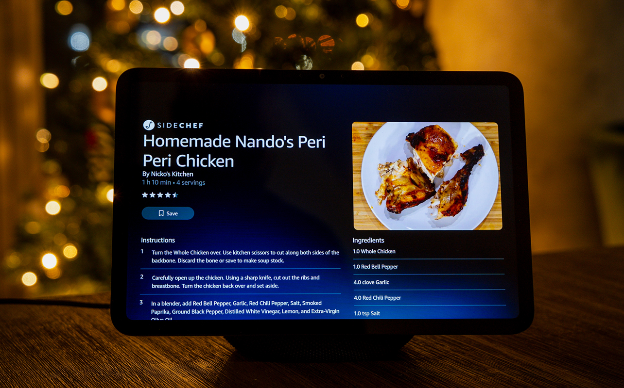Amazon Echo Show 11 on table in front of Christmas tree.