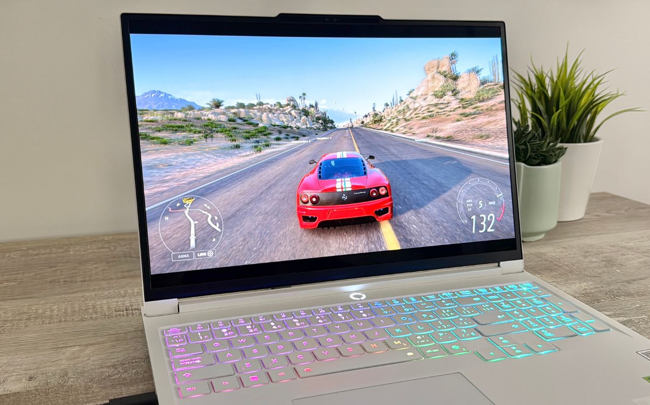 The Lenovo Legion 7i laptop is running Forza Horizon 5, with a red Ferrari on screen.