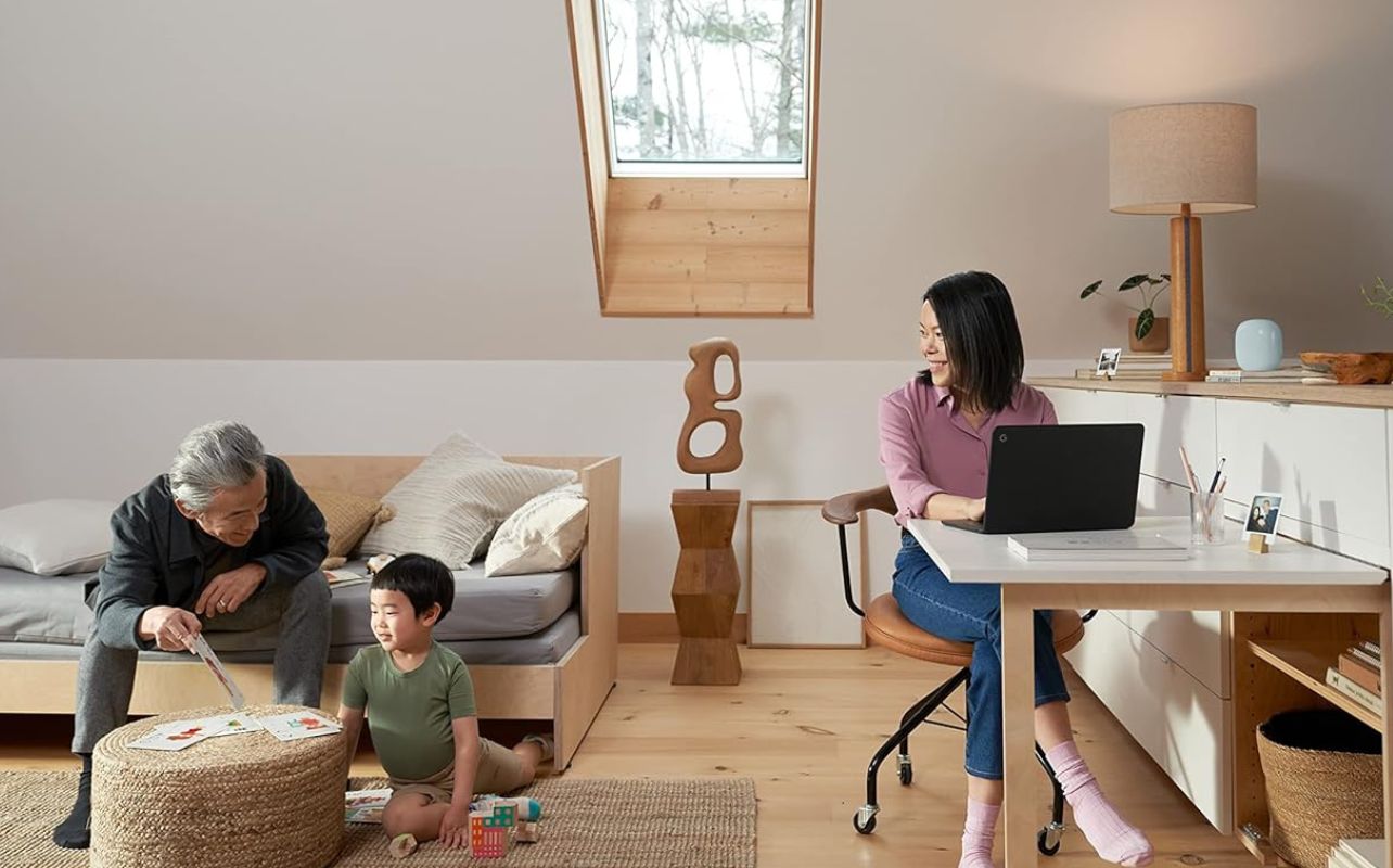 Family enjoying activities around a Nest Wi-Fi Mesh system.