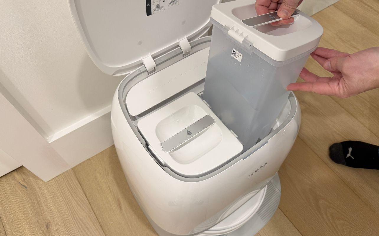 Refilling the Roborock Qrevo Curv Robot Vacuum with water and loading it up.