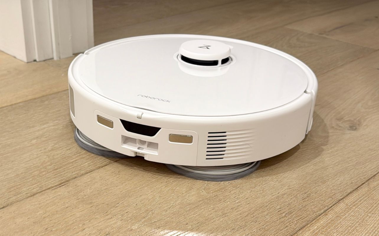 The Roborock Qrevo Curv Robot Vacuum mopping a wood floor.