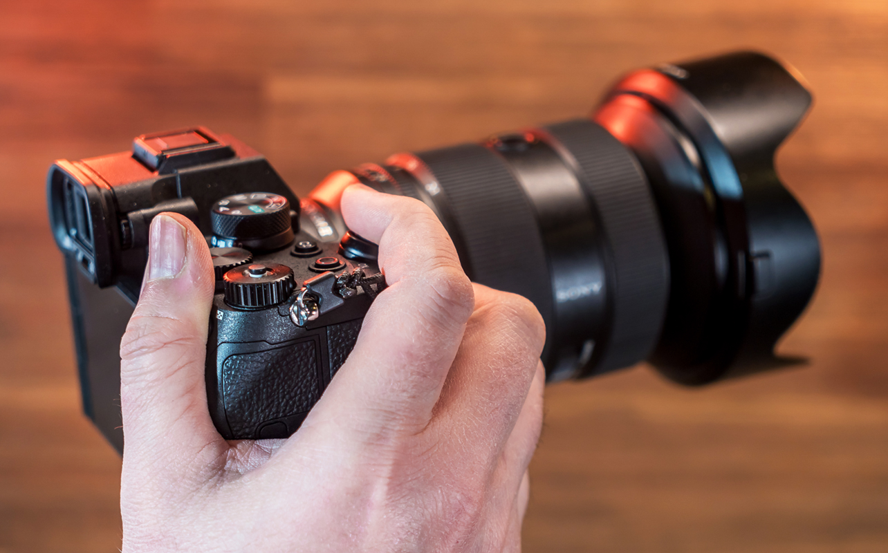 Sony A7 V camera grip in hand.