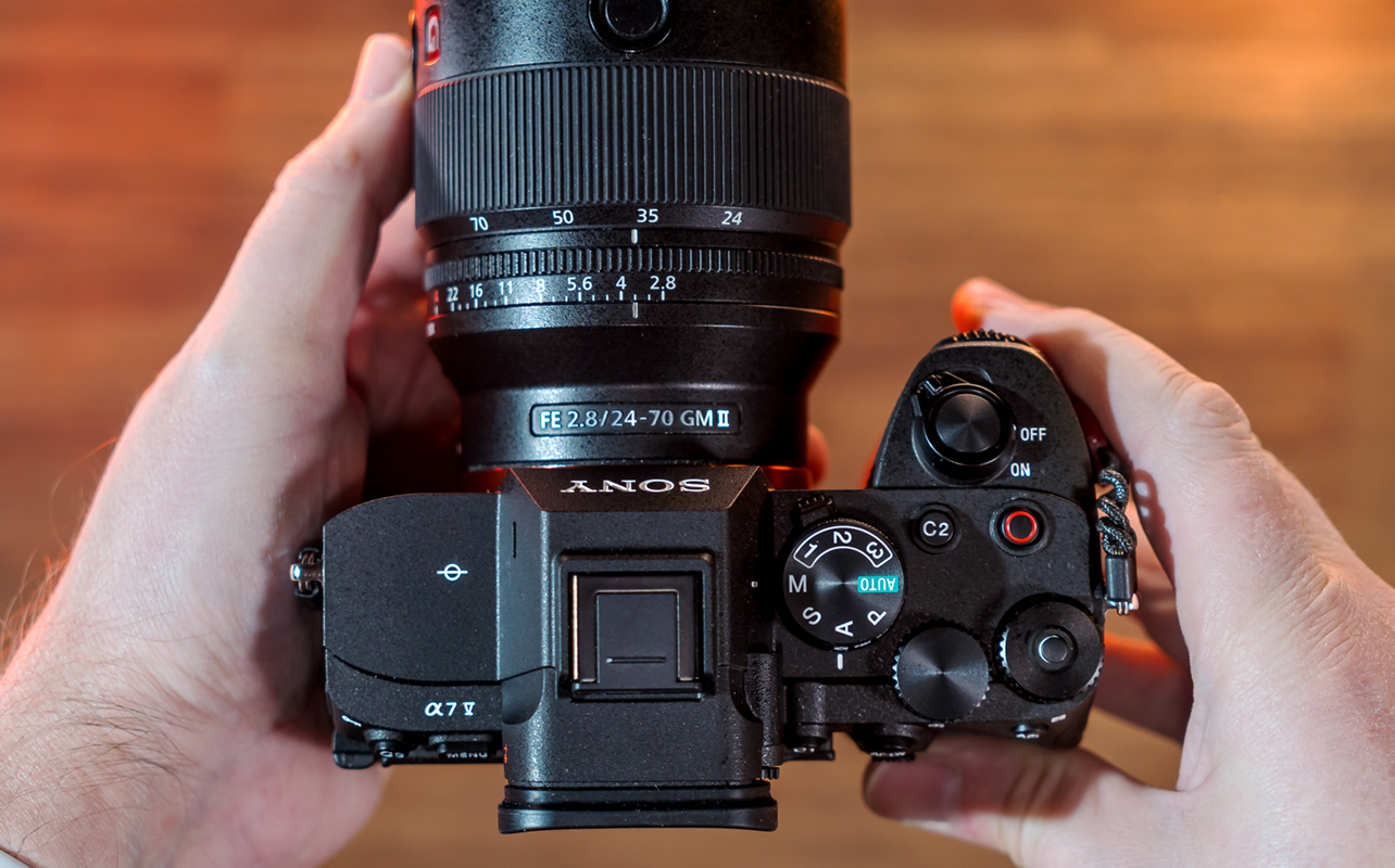 Sony A7 V camera in hand top-down view.