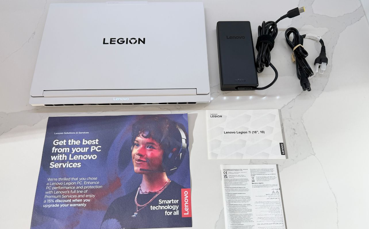 The Lenovo Legion 7i laptop with all of its components unboxed.