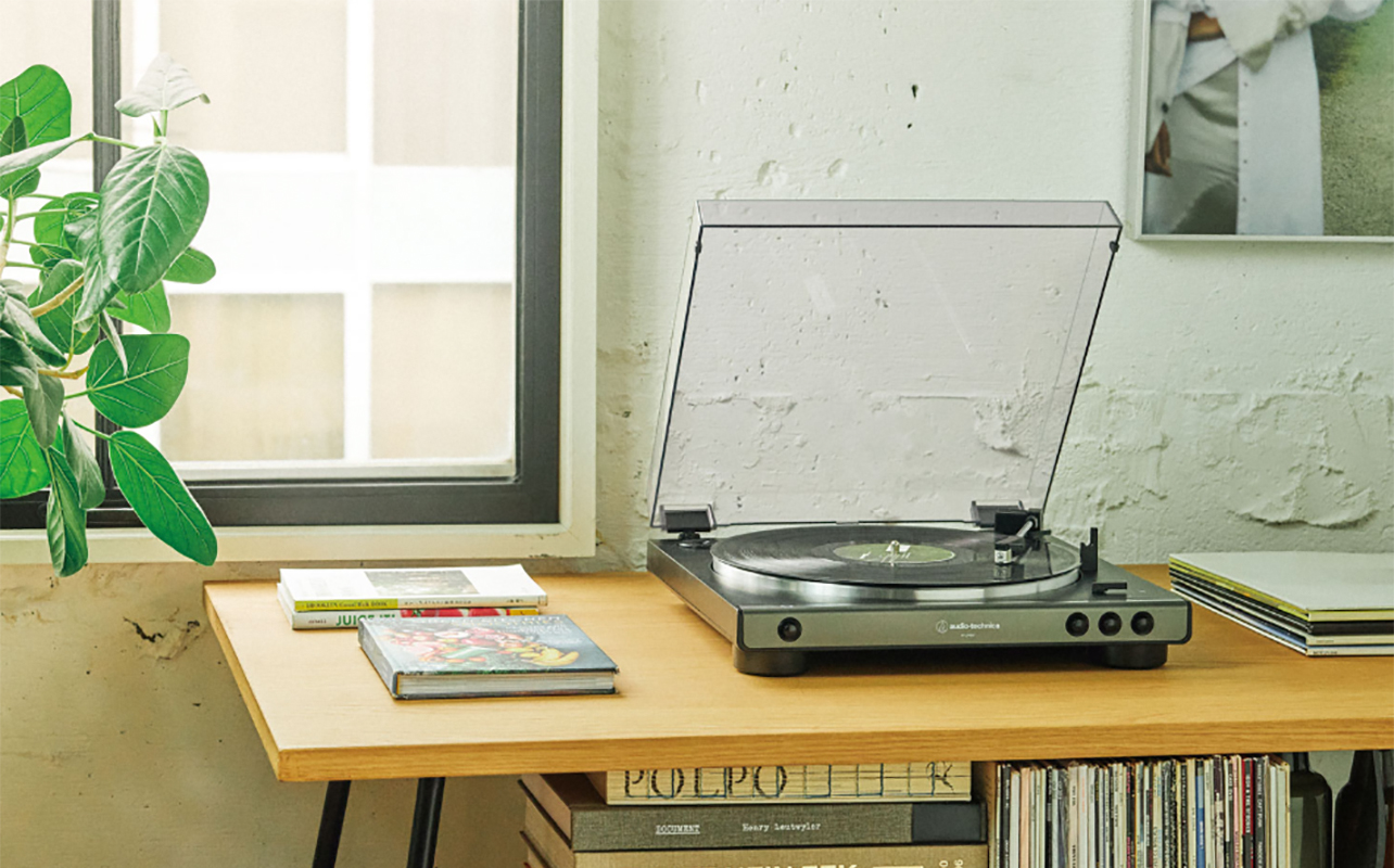An Audio Technica ATLP60 turntable on a small table.