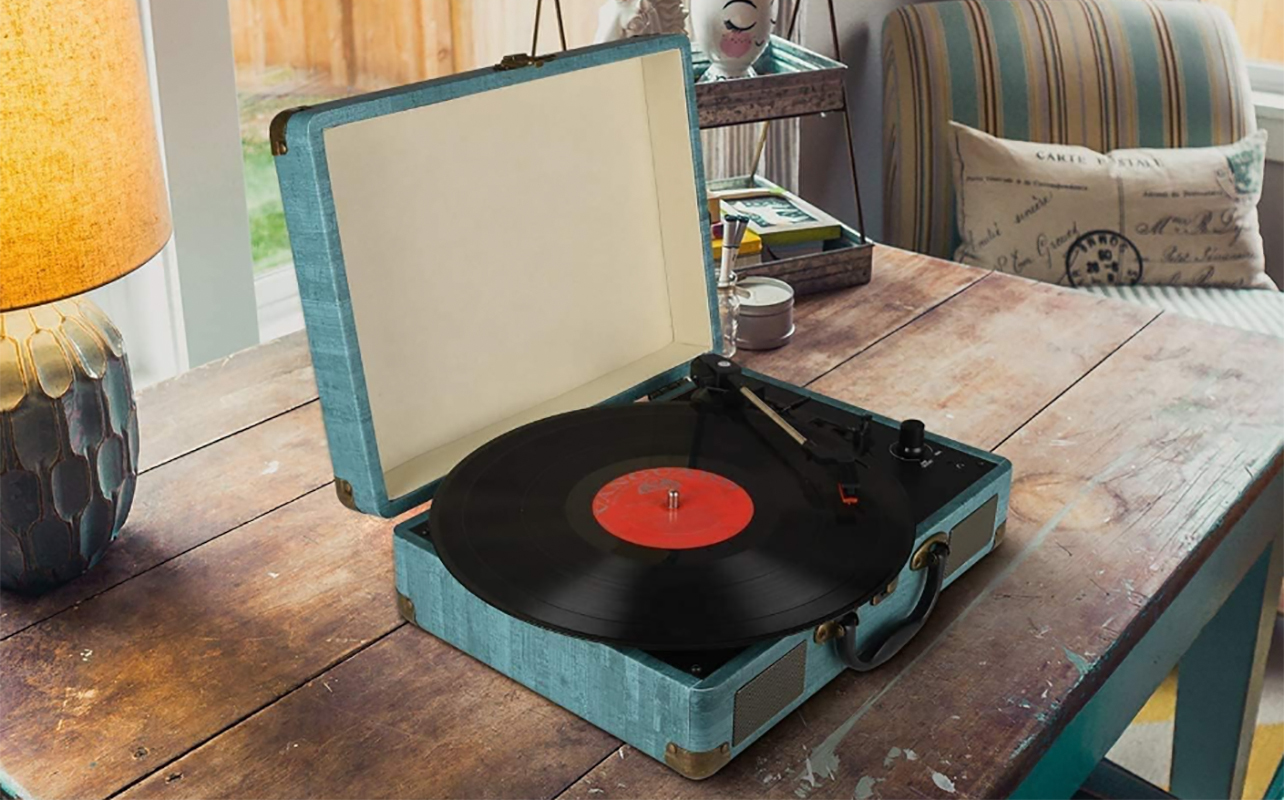 A Bluetooth suitcase turntable on a table.
