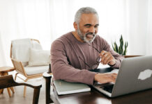 Senior men filing taxes online