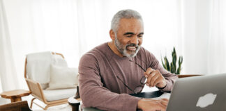 Senior men filing taxes online