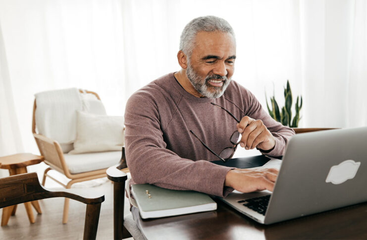 Senior men filing taxes online