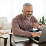 Senior men filing taxes online
