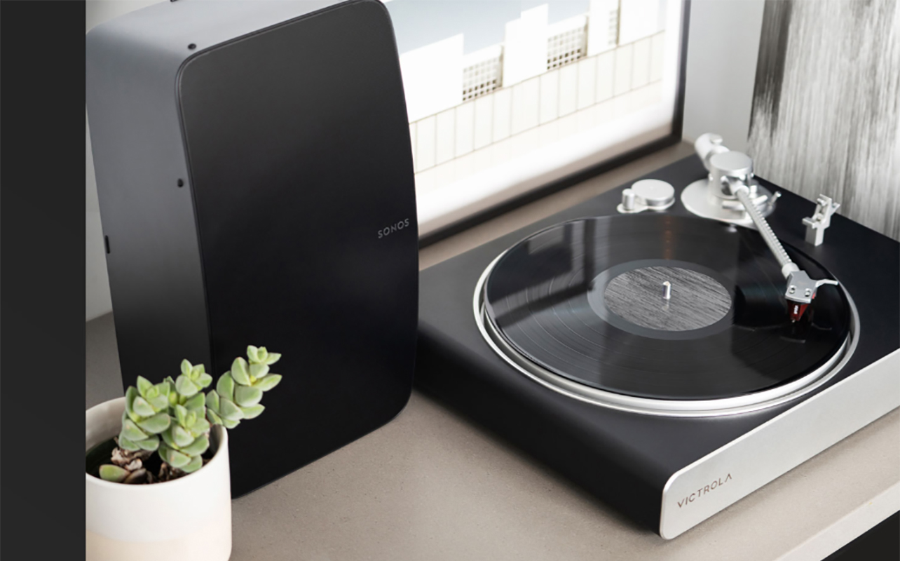 Victrola Stream Carbon beside a Sonos speaker