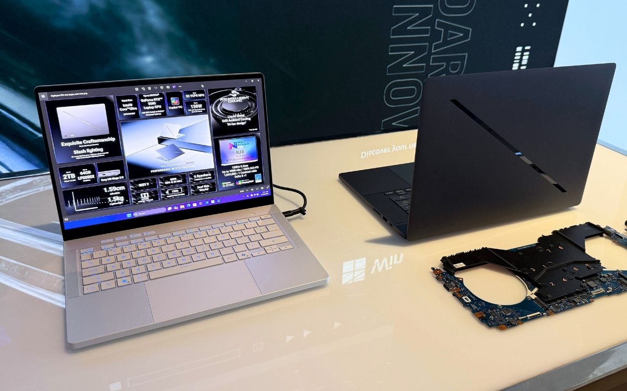 Two gaming laptops sit on a table. 