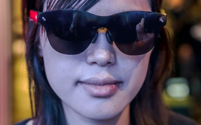 Woman wearing smart glasses looking ahead at CES 2026.