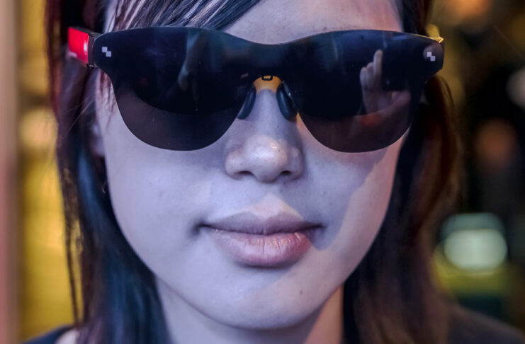 Everybody’s wearing smart glasses at CES 2026 Woman wearing smart glasses looking ahead at CES 2026.