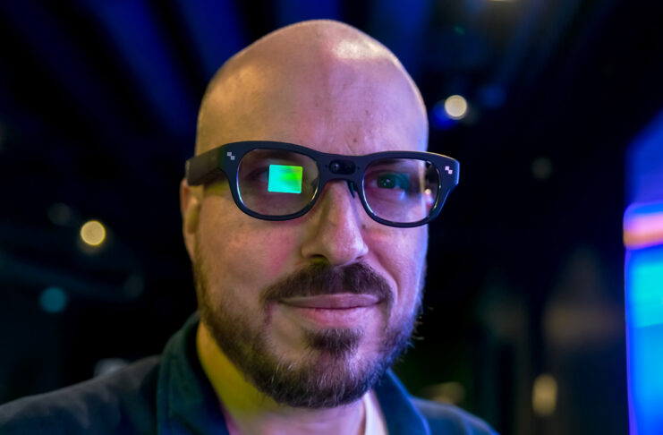RayNeo X3 Pro AR glasses on face with visible visual screen on right eye.