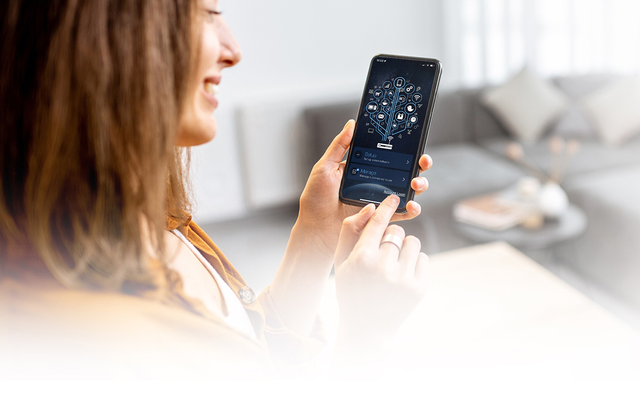 A woman holding a phone showing the Asus router app