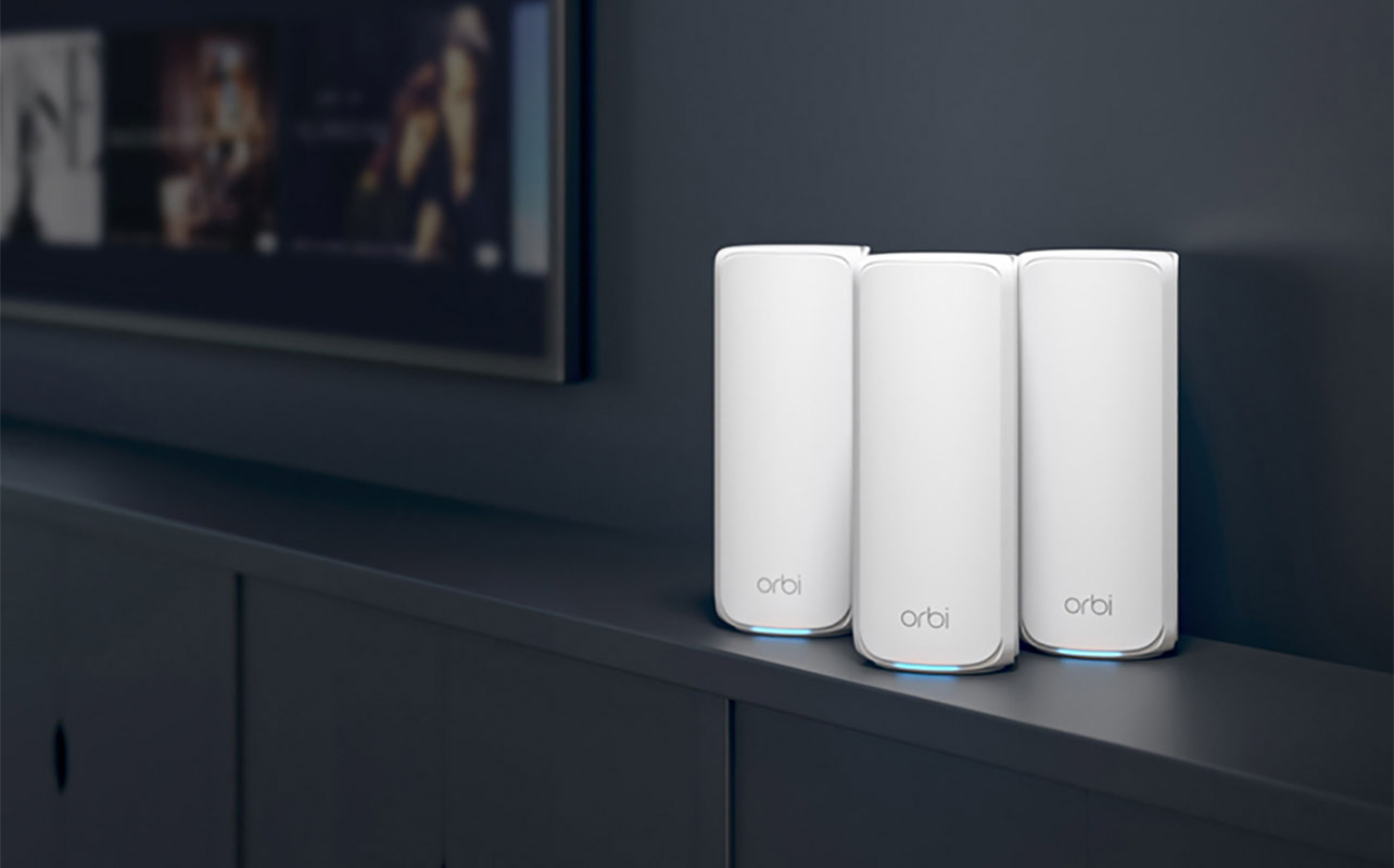Netgear Orbi mesh network nodes on a table.