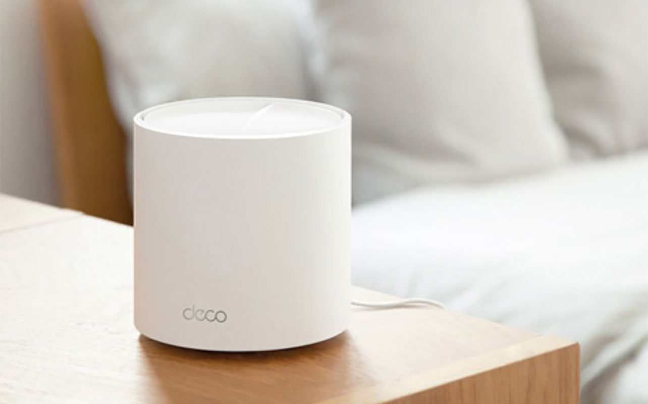 A TP-Link Deco X50 router on a table.