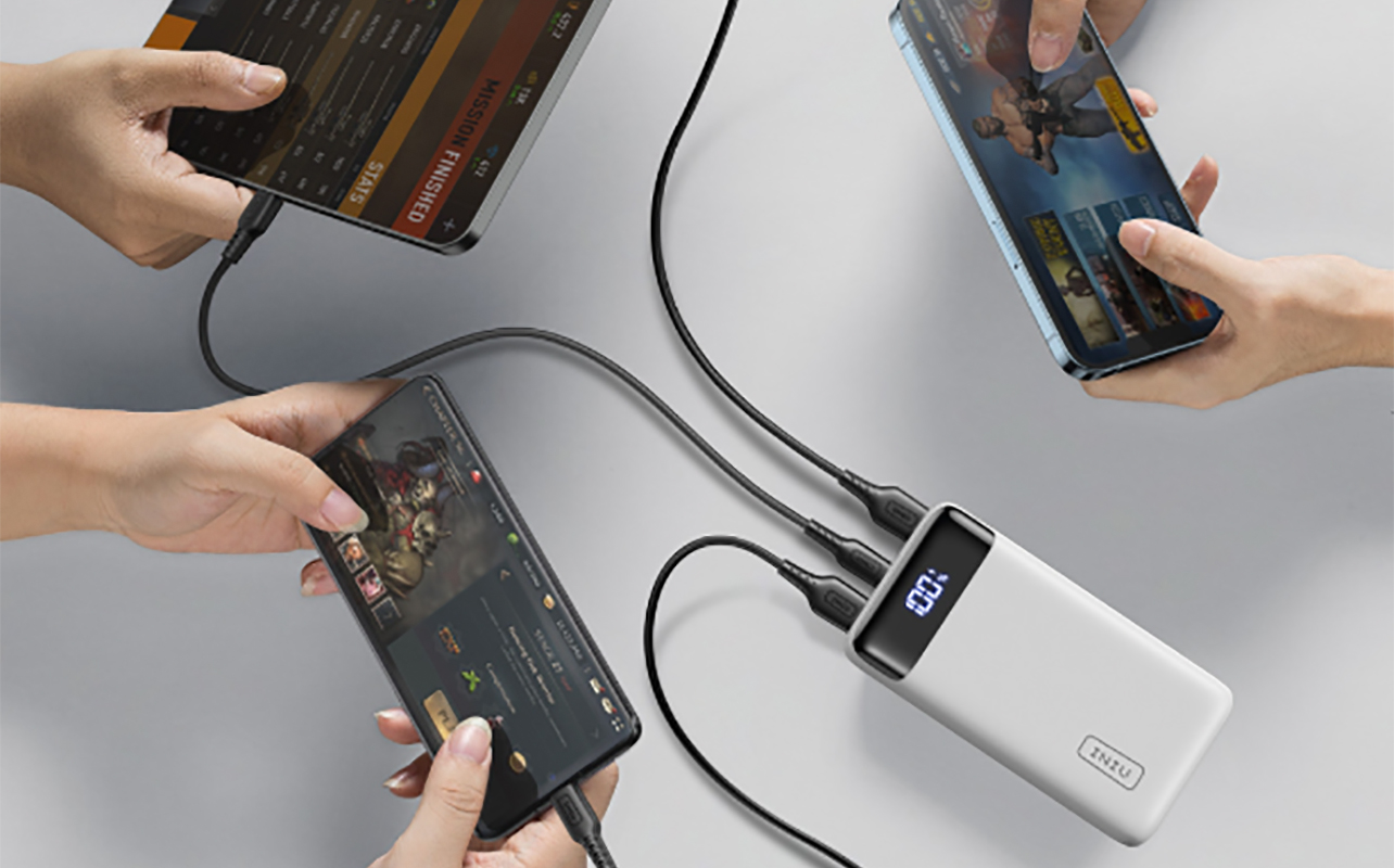 An overhead view of the INIU 20,000 mAh power bank charging multiple devices.