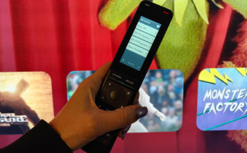 A smarter universal remote for busy living rooms: One For All Smart Pro Touch review One For All Smart Pro Touch remote in front of a TV.