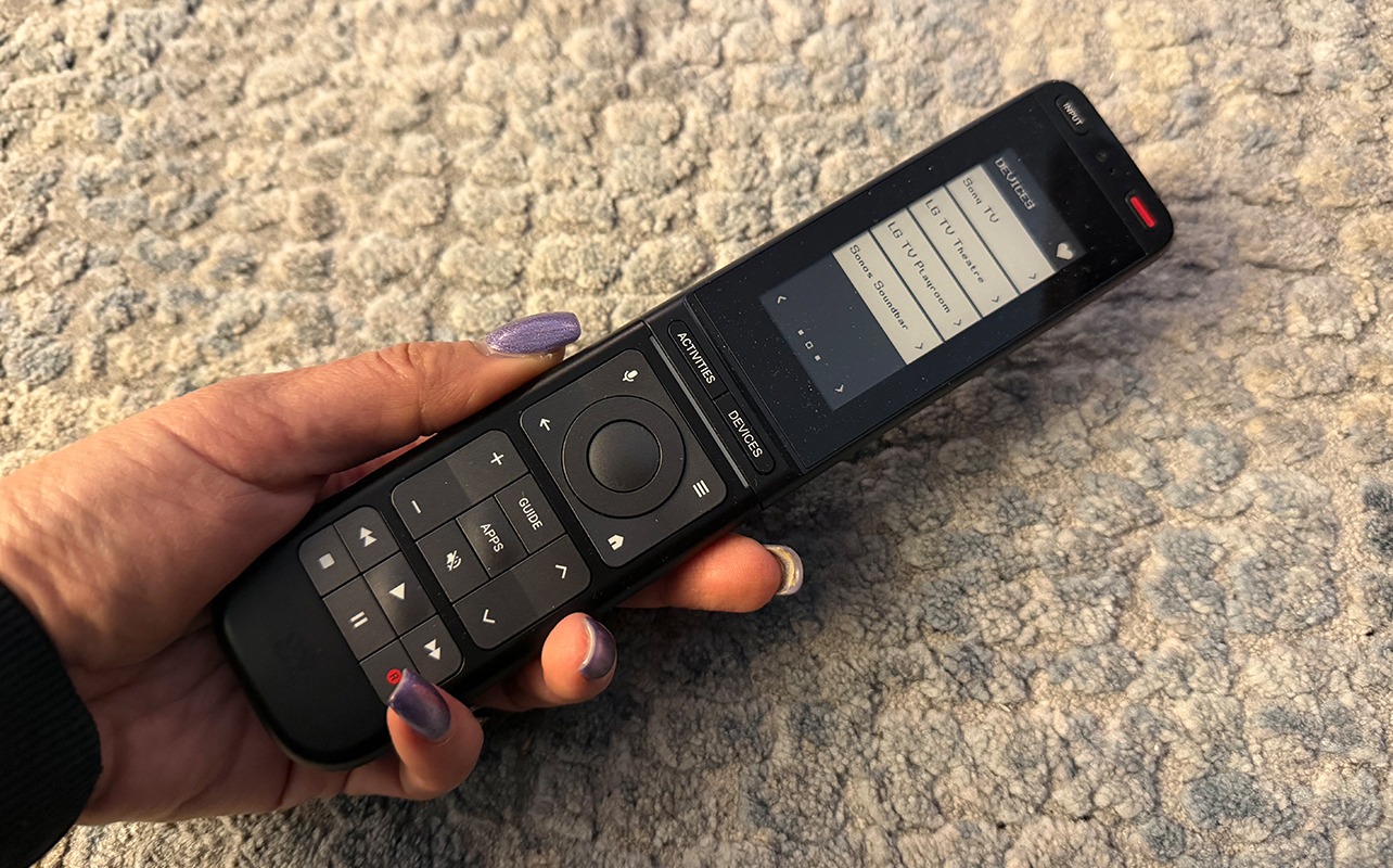 The One For All Smart Pro Touch remote in hand.