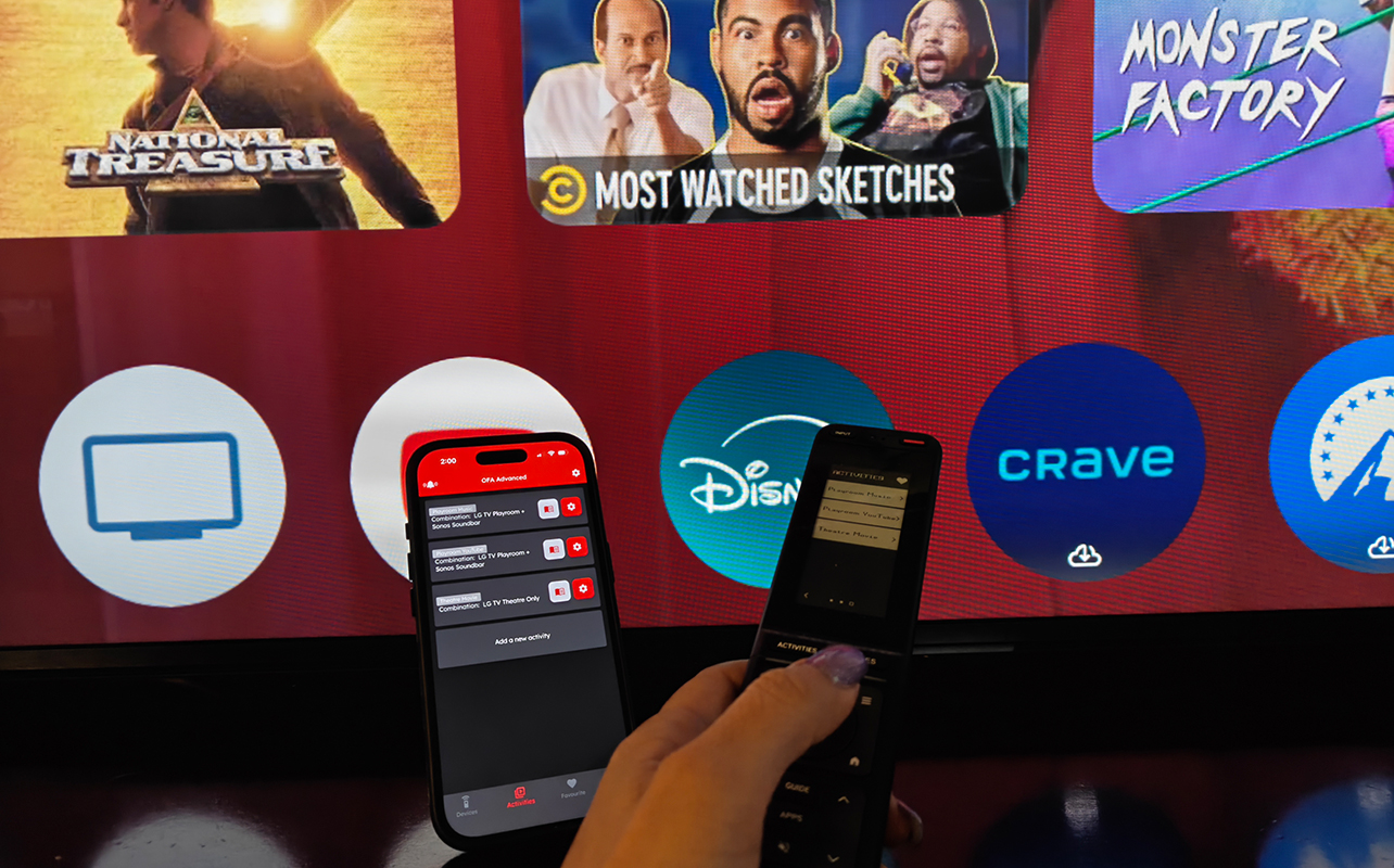 The One For All Smart Touch Pro remote in front a TV with an iPhone showing the companion app.