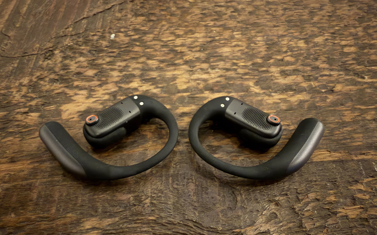 Shokz OpenFit Pro earbuds on a table.