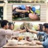 Four friends on a patio clinking glasses, a Neptune Full Sun outdoor TV behind them.