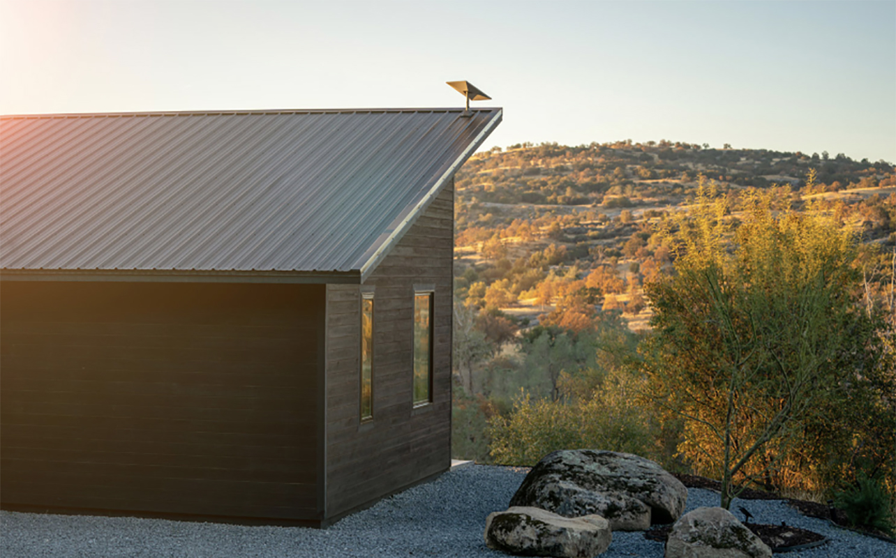 A Starlink Standard Kit on the roof of a remote house.