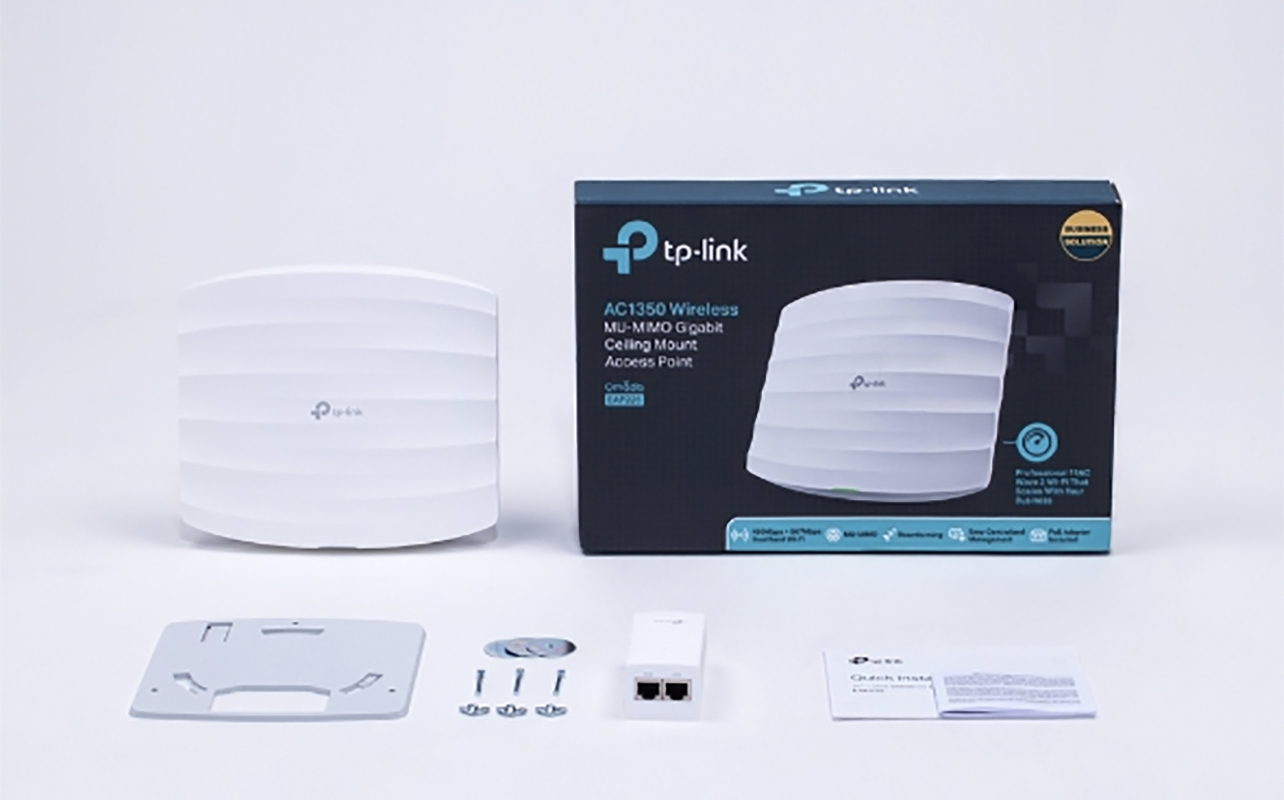 A TP-Link modem with various accessories in front of its box.