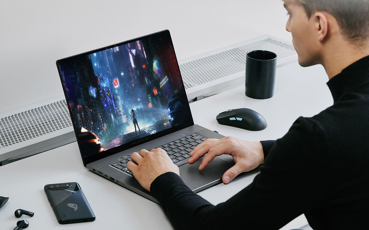 Person playing game on gaming laptop